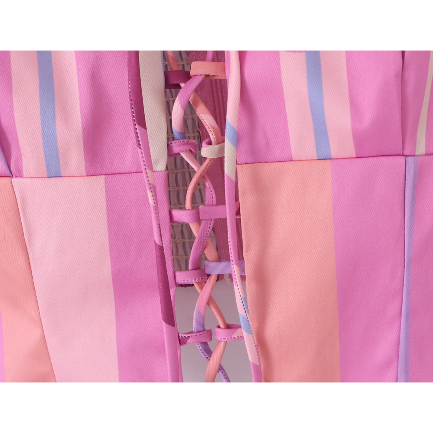 Macro shot of multi-color matching ribbon crisscross lace-up hollow-out front corset craft, neat edge stitching