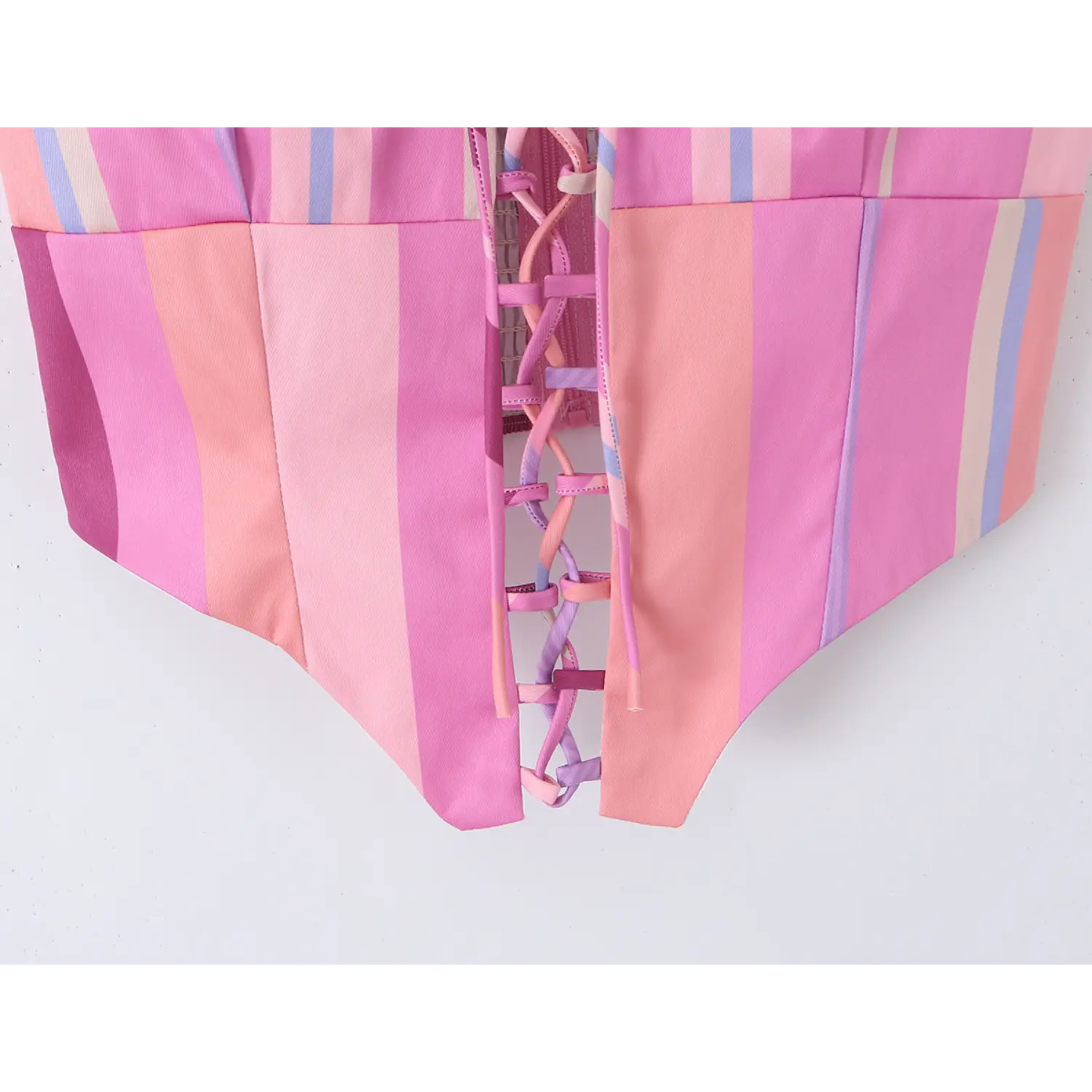 Full front lower torso shot showing complete ribbon lace-up and pointed jagged hem silhouette