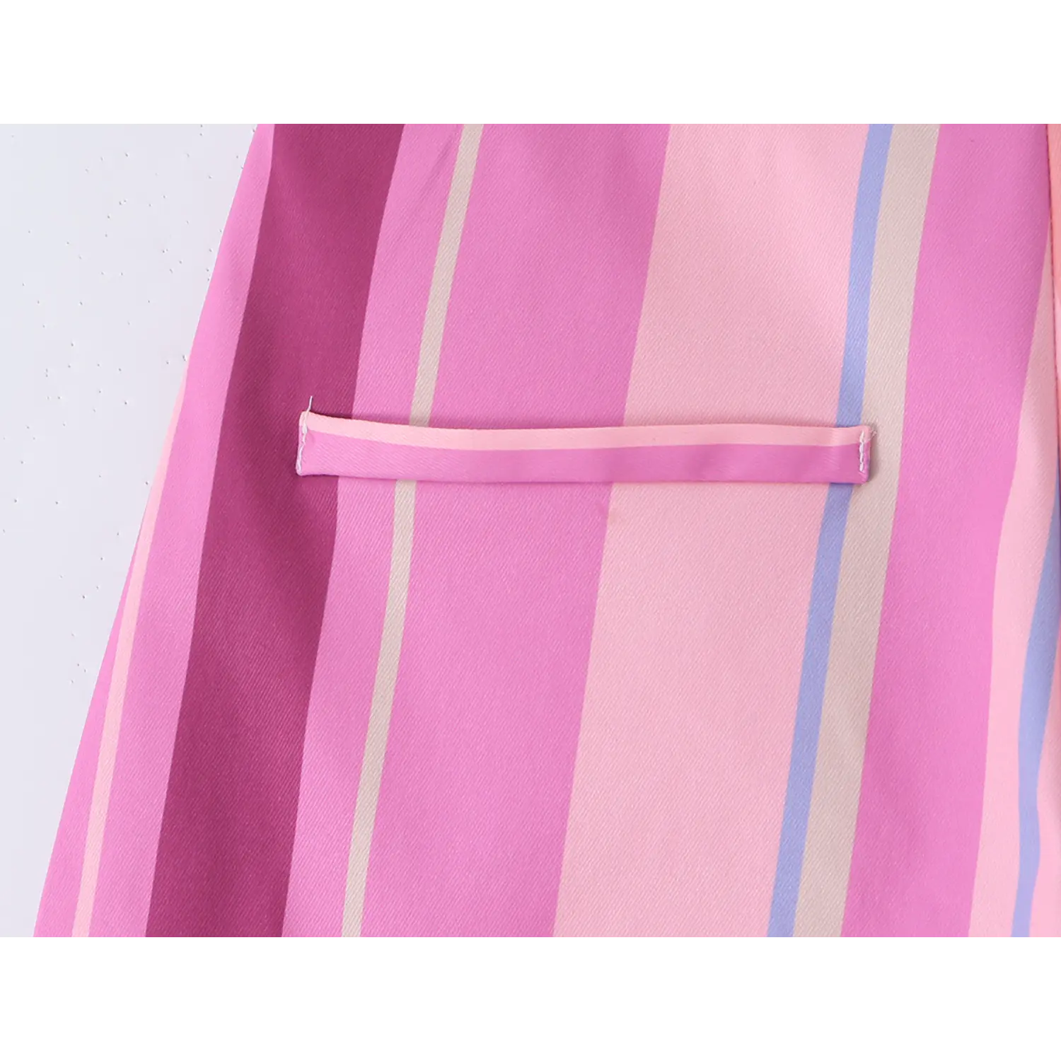 Close-up of rear horizontal welt pocket, matching pink binding edge and uniform topstitching