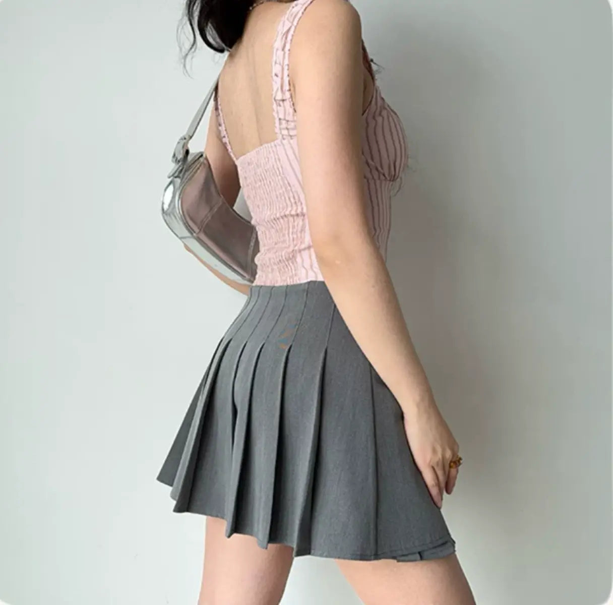 Back view of pink striped corset-style cami top with adjustable straps and fitted waist