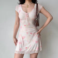 Pink tulip dress styled with a brown handbag