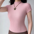Model wearing pink waffle-knit mock-neck top with short sleeves, fitted textured t-shirt