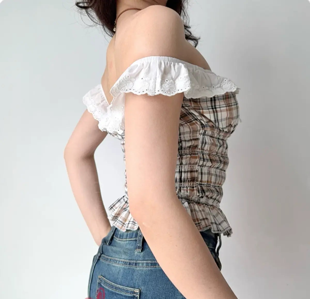 Side view of plaid off-shoulder ruffled top