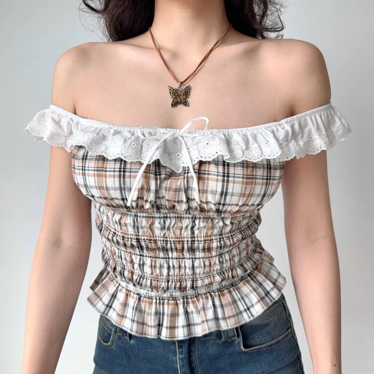 Plaid off-the-shoulder top with ruffled trim