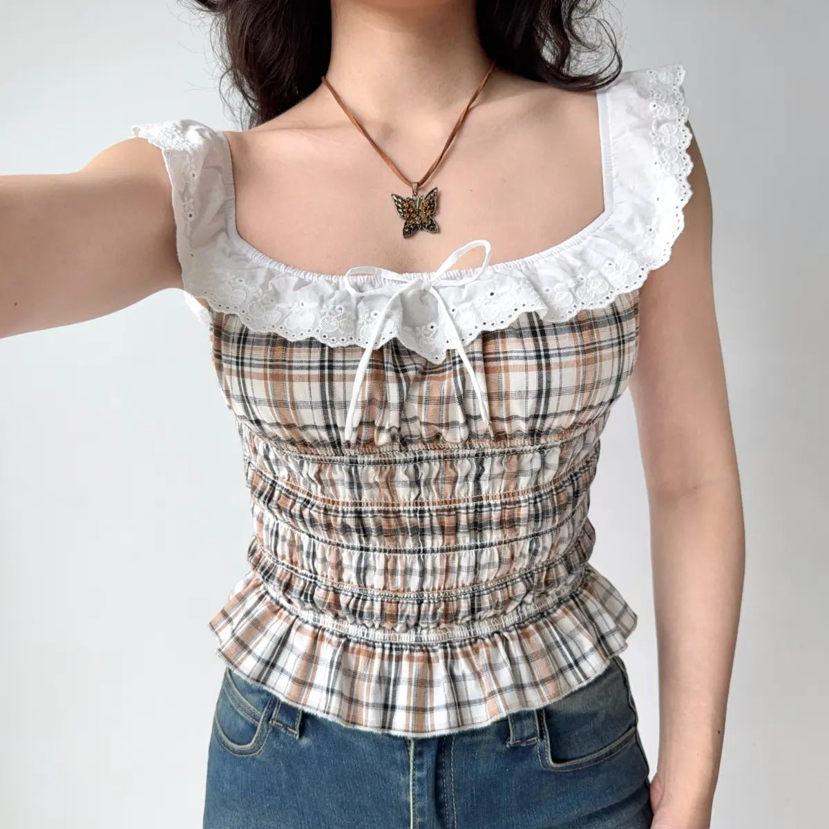 Plaid ruffled top, arm up view