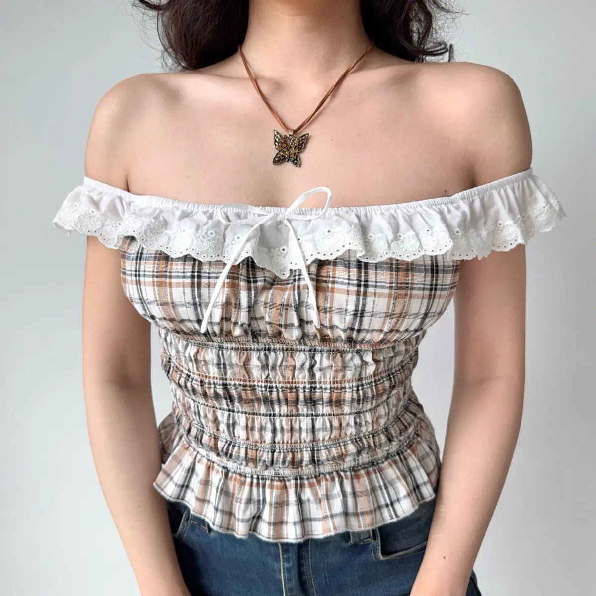 Close-up of plaid off-the-shoulder top