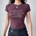 Outfit view of plum t-shirt styled with dark denim jeans, highlighting the stretchy fabric