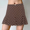 Model wearing brown white polka dot flounce mini skirt with ruffled hem