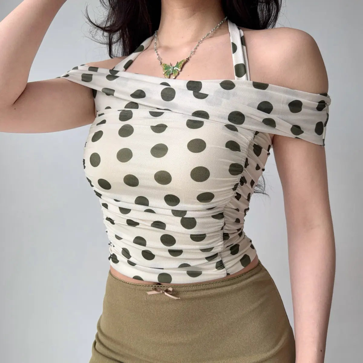 Model in polka dot halter top, three-quarter view
