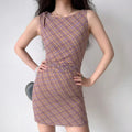 Model wearing purple brown plaid sleeveless mini dress with twist detail, retro bodycon party dress