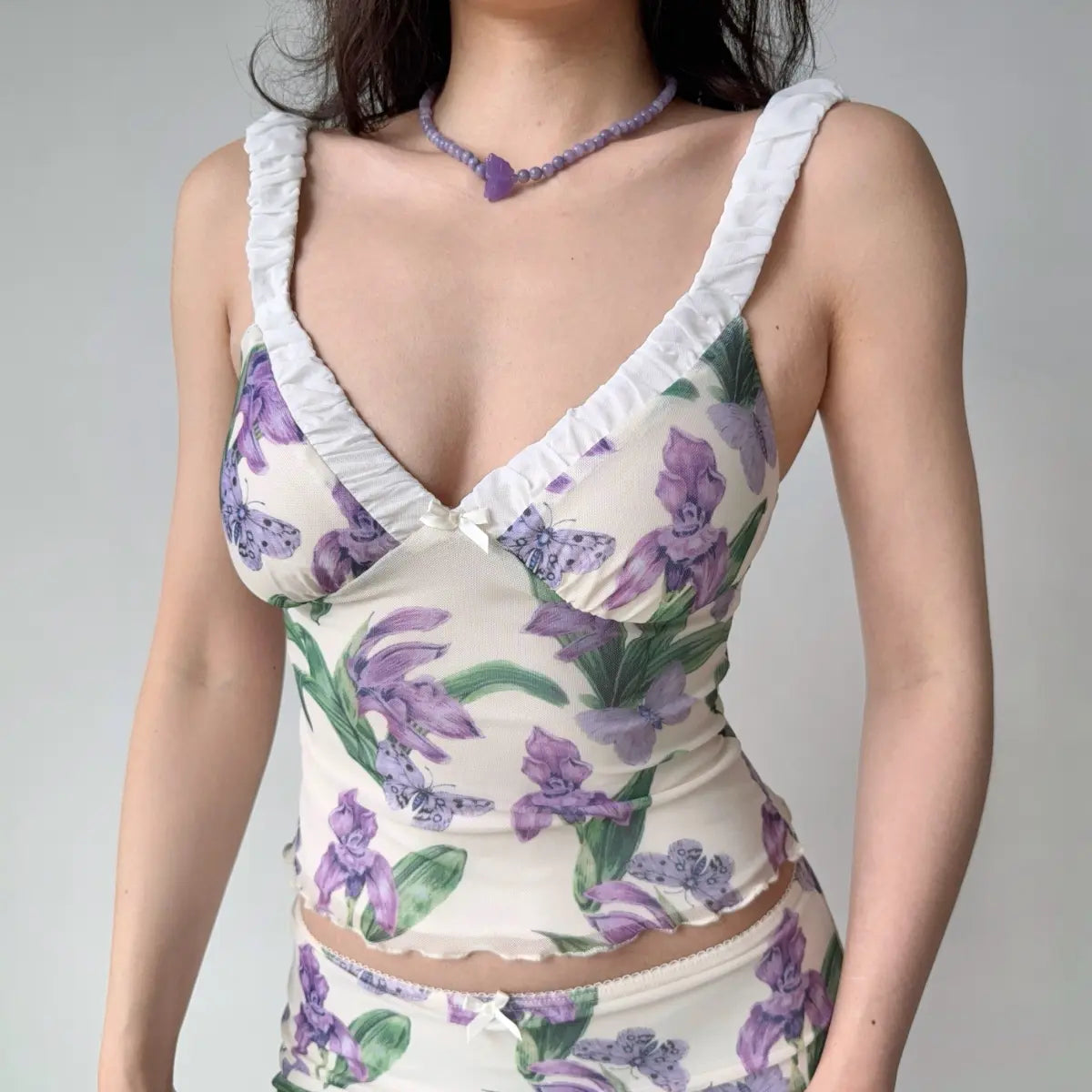 Close-up of model wearing purple iris print mesh cami top