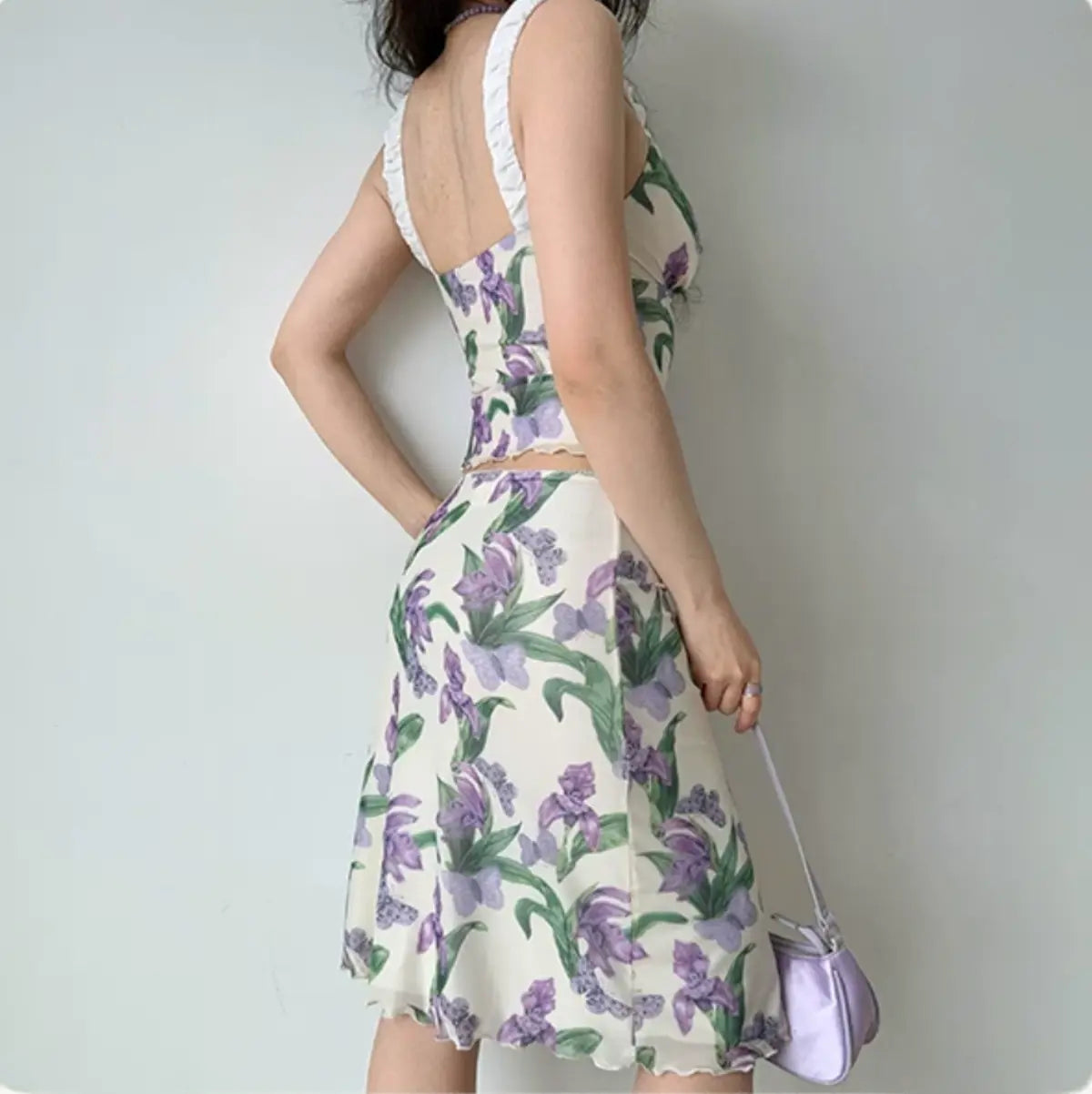Model wearing purple iris print mesh cami and midi skirt set, back view