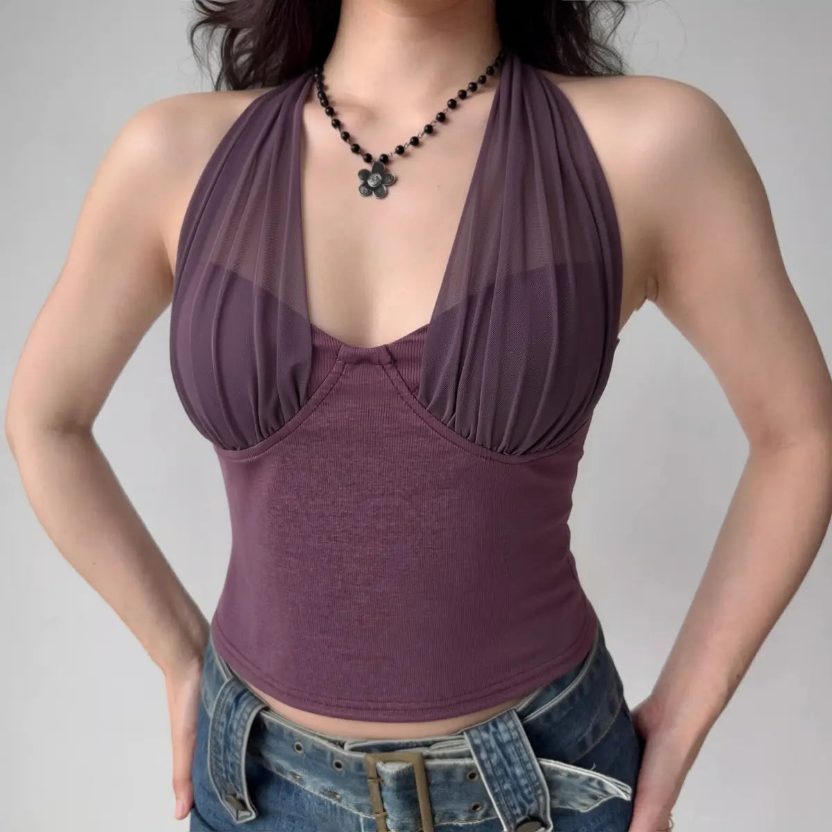Model wearing purple mesh halter-neck cropped top with ruched bust, feminine Y2K-inspired cami