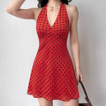 Model wearing red black polka dot halter-neck mini dress, retro Y2K-inspired party dress
