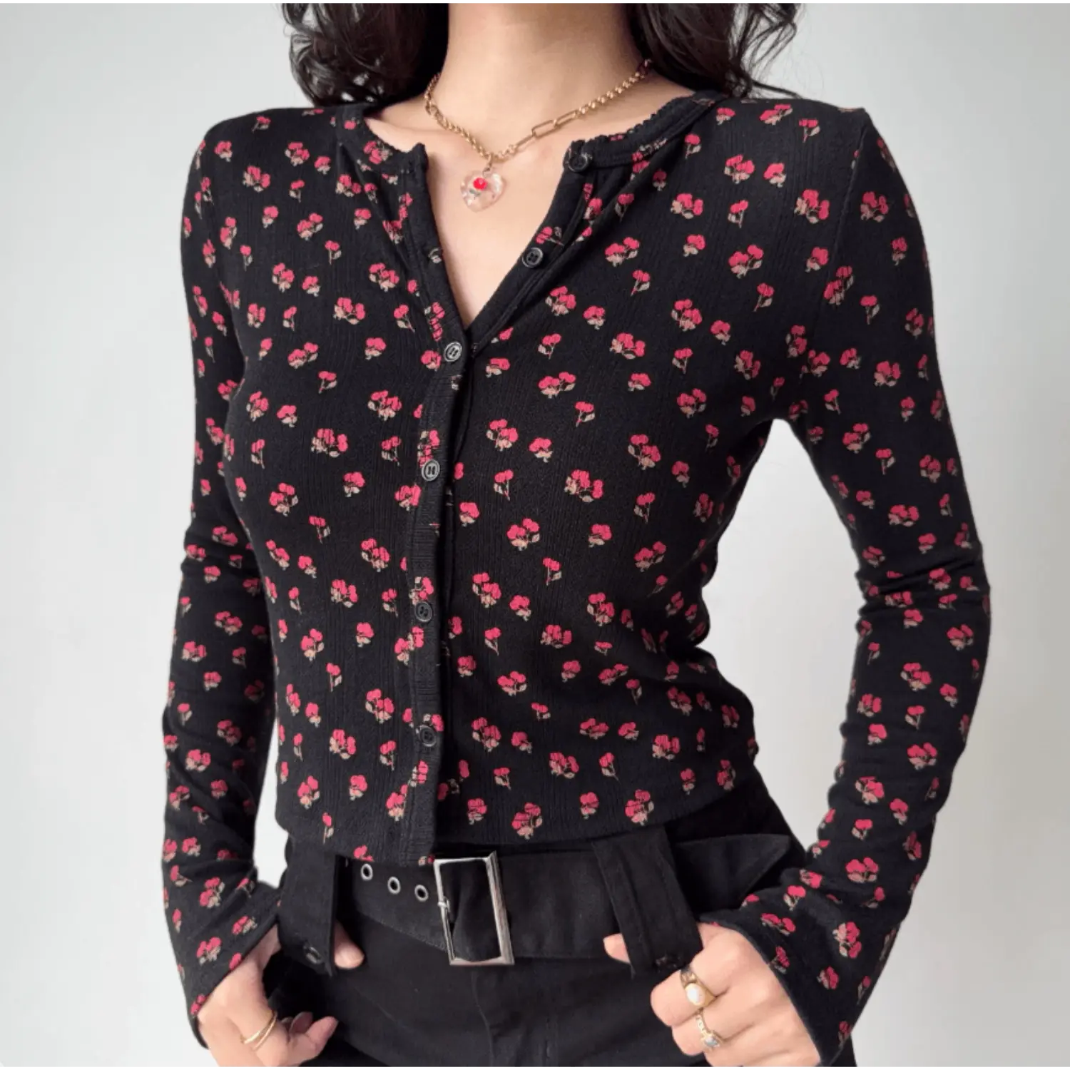 Model front view wearing black ditsy red floral print button‑down long sleeve fitted top