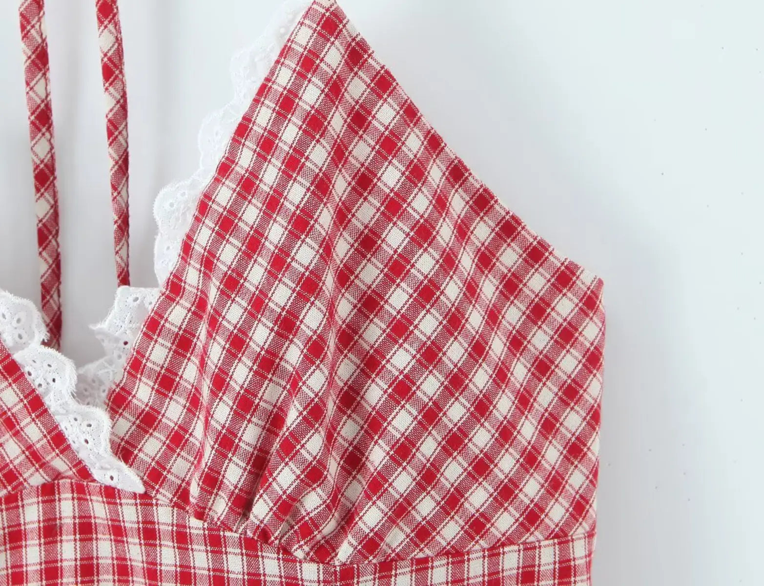 Lace trim detail at the neckline of red gingham halter dress