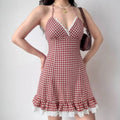 Model wearing red gingham halter mini dress, front view