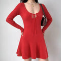 Red ribbed knit mini dress with scalloped neckline, tie detail, and flared hem