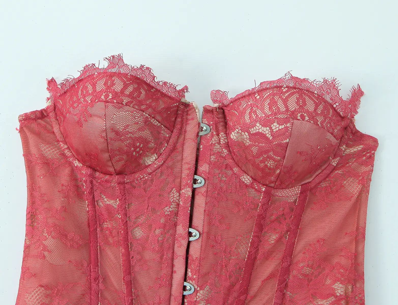 Bust and button detail of red lace strapless corset top