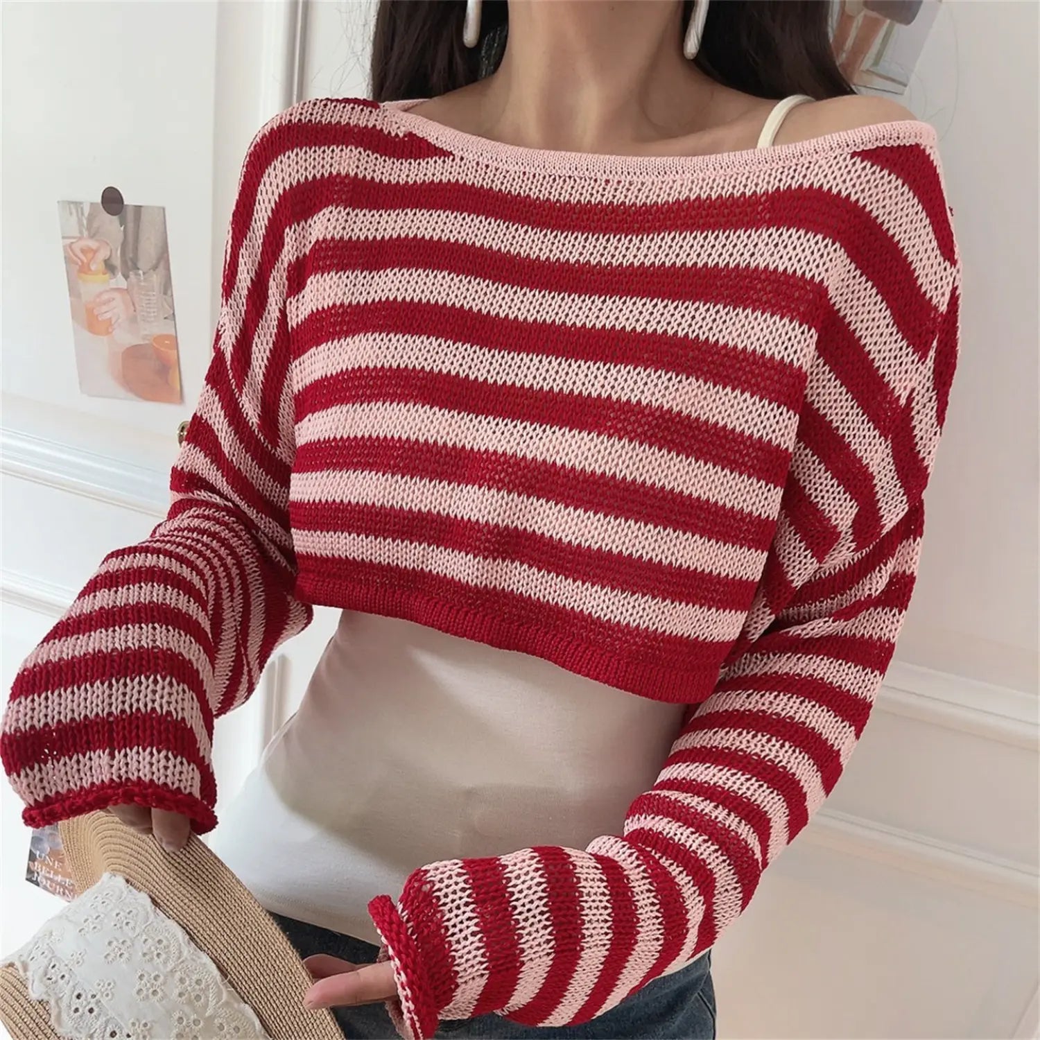 Front real shot of red light pink striped off shoulder cropped knit top, hollow mesh loose knit fabric, long flared cuffs