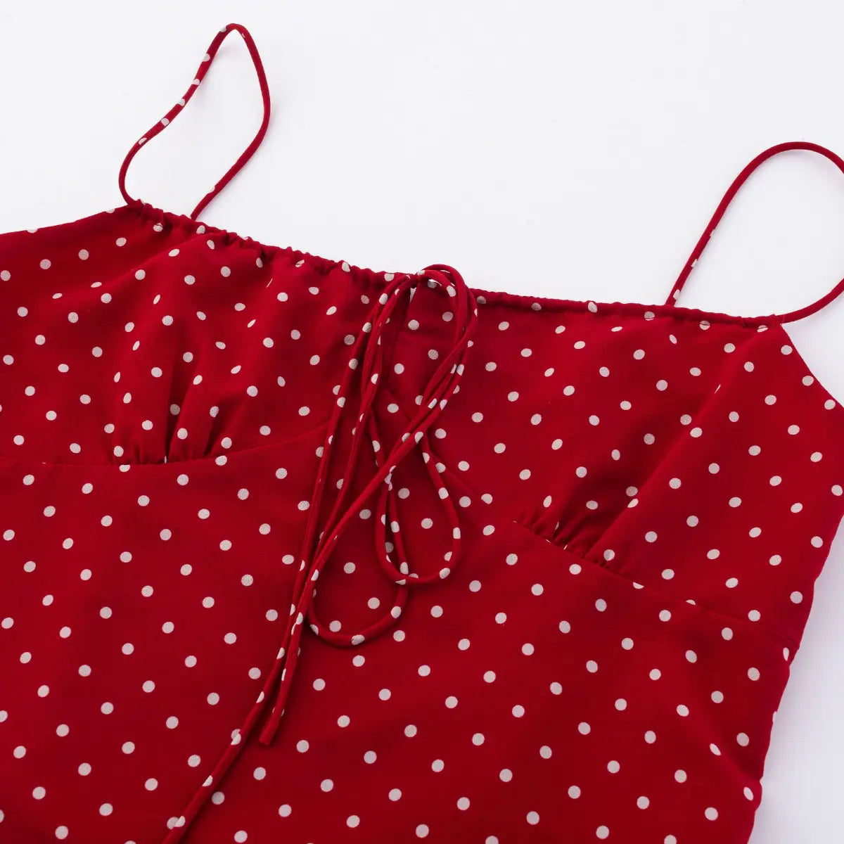 Close-up of front tie closure detail on red polka dot cami top
