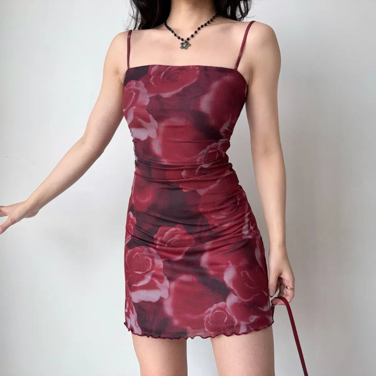 Side view of red rose print mesh mini dress
