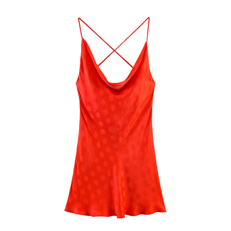 Hanger view of red satin dress showing the cowl neck, subtle polka dot jacquard, and flowy silhouette