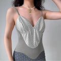 Model wearing silver glitter cami top with herringbone knit panels, fitted bustier-style spaghetti-strap top