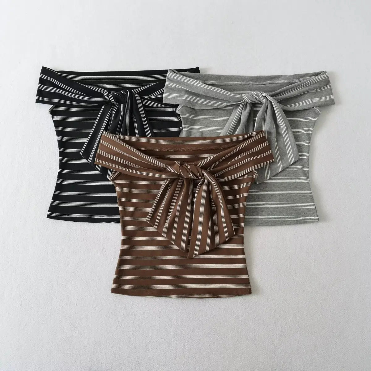 Multi-color view of striped off-the-shoulder tube top, available in brown, black and gray