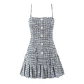Front view of tweed cami dress with button details and pleated skirt
