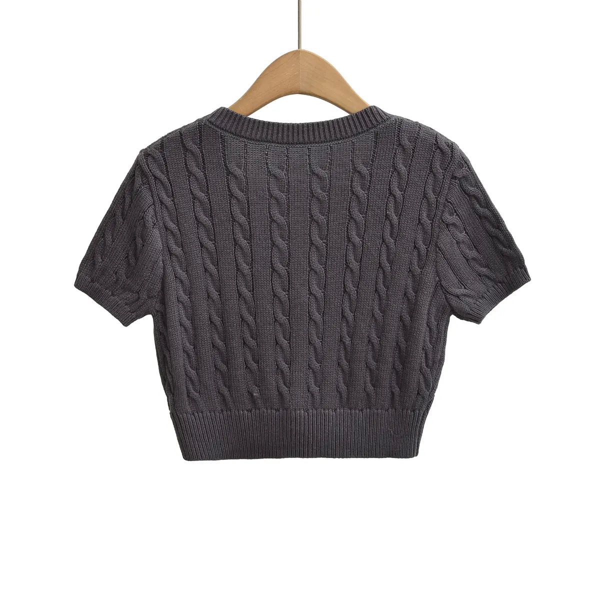 Back view of cable-knit cropped short-sleeve cardigan with ribbed V-neck and hem