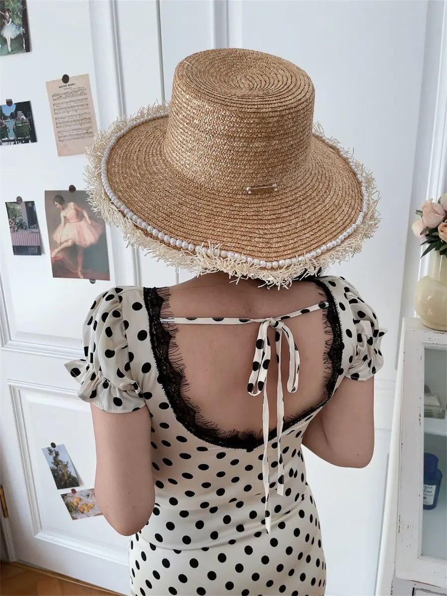 Model in white and black polka dot lace-trim maxi dress, back view