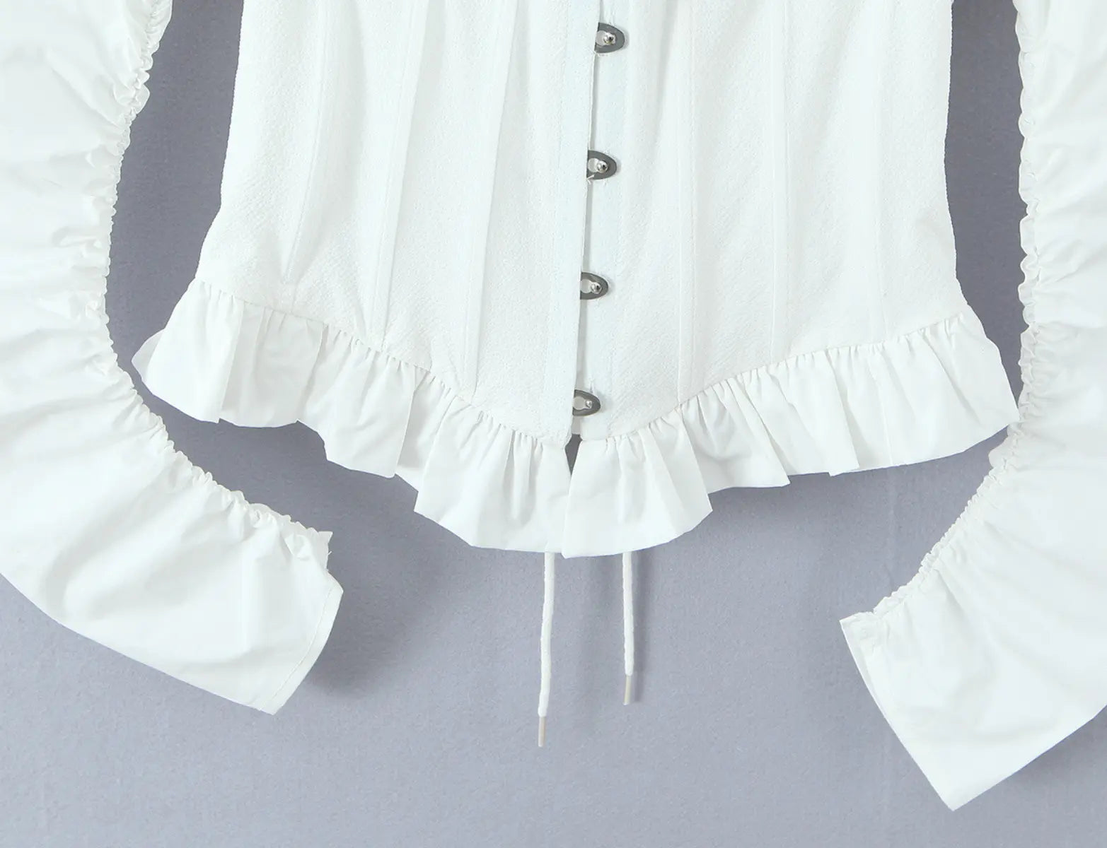 Ruffled hem detail of white square-neck bustier top