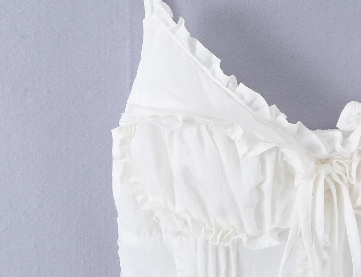 Close-up of the sweetheart neckline and front tie bow on the white cami top