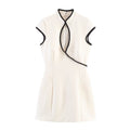 Front flat view white contrast black piping mandarin collar hollow keyhole cutout neck sleeveless high waist slim flared hem cheongsam mini dress, elegant chic party dress
