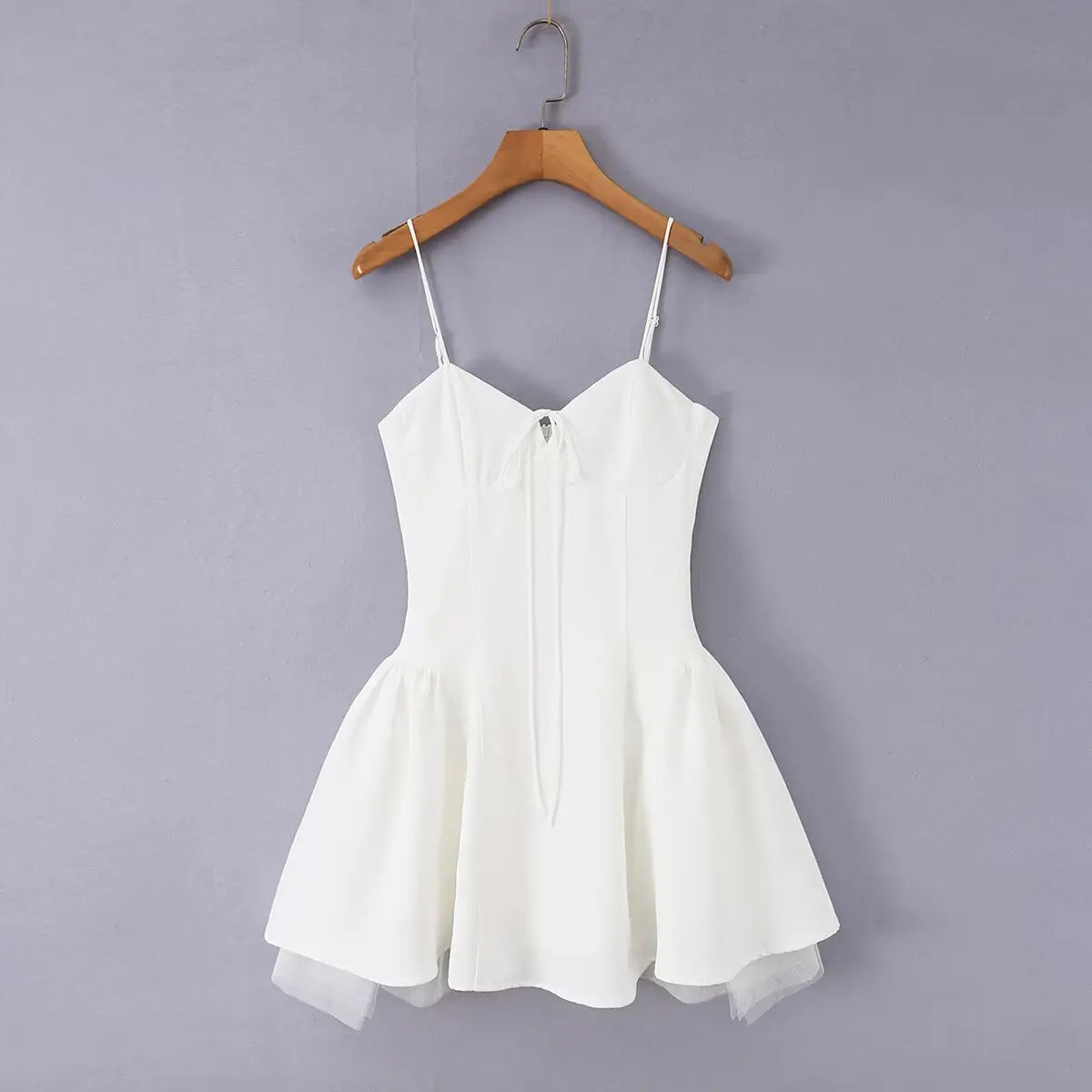 White corset bow mini dress, front view on hanger, grey background