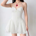 Model in white corset bow mini dress, front view