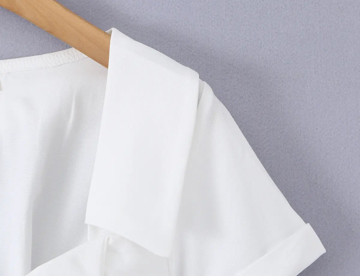 Close-up of the structured notched collar and short sleeve on the white corset shirt