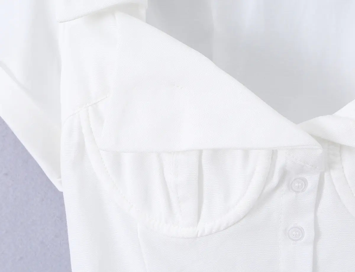 Close-up of the bustier-style cups and front button placket on the white shirt