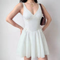 Model in white corset sleeveless mini dress, front view