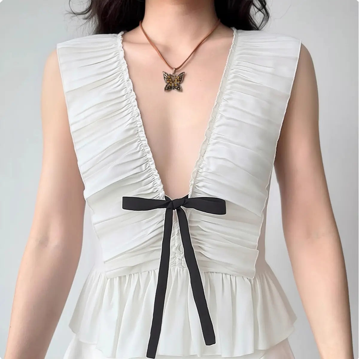 Model wearing blush pink cami dress with thin straps and bubble hem, flowy airy slip dress