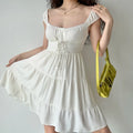 Close-up view of white tiered mini dress