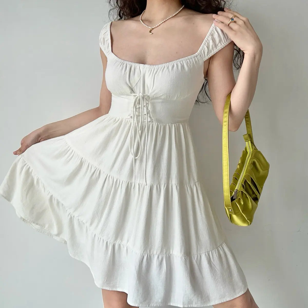 Close-up view of white tiered mini dress