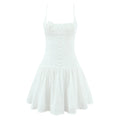 Front flat view white embroidered floral spaghetti strap mini dress with floral appliqu and button detail, feminine summer party outfit
