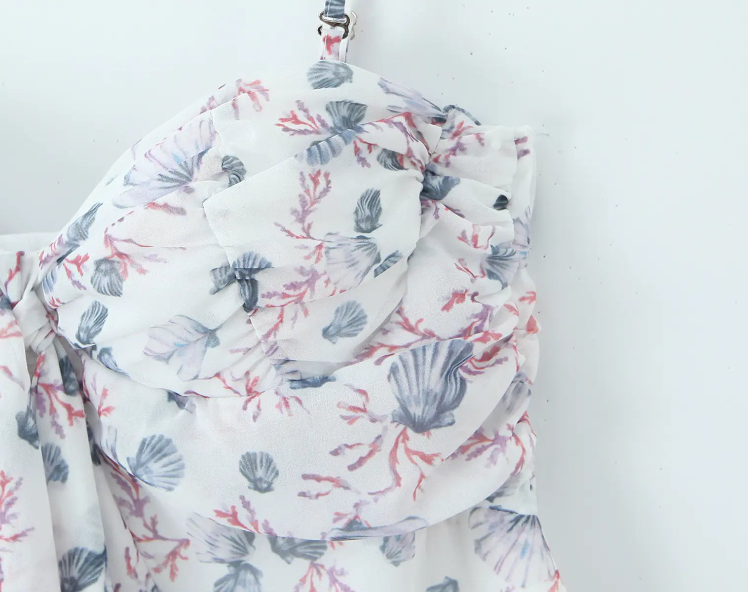 Close-up of white floral cami mini dress on model