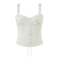 Front view of white floral print corset-style cami top with lace-trimmed bust and fitted boned silhouette