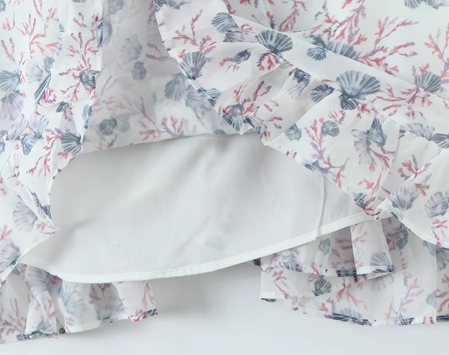 Fabric and lining detail of white floral cami mini dress