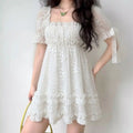 Model wearing white floral lace puff-sleeve mini dress with ruffle hem, romantic fairycore party dress