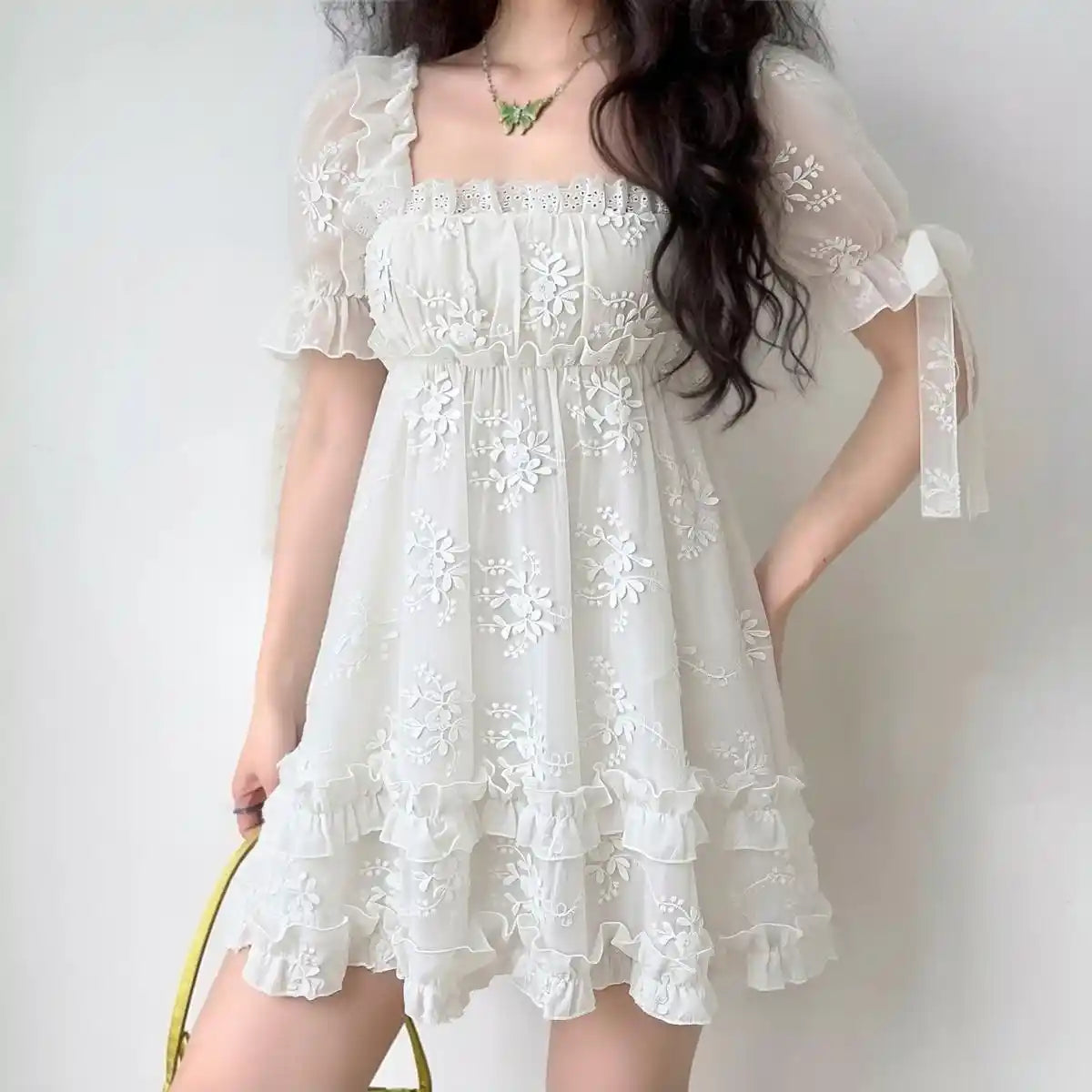 Model wearing white floral lace puff-sleeve mini dress with ruffle hem, romantic fairycore party dress