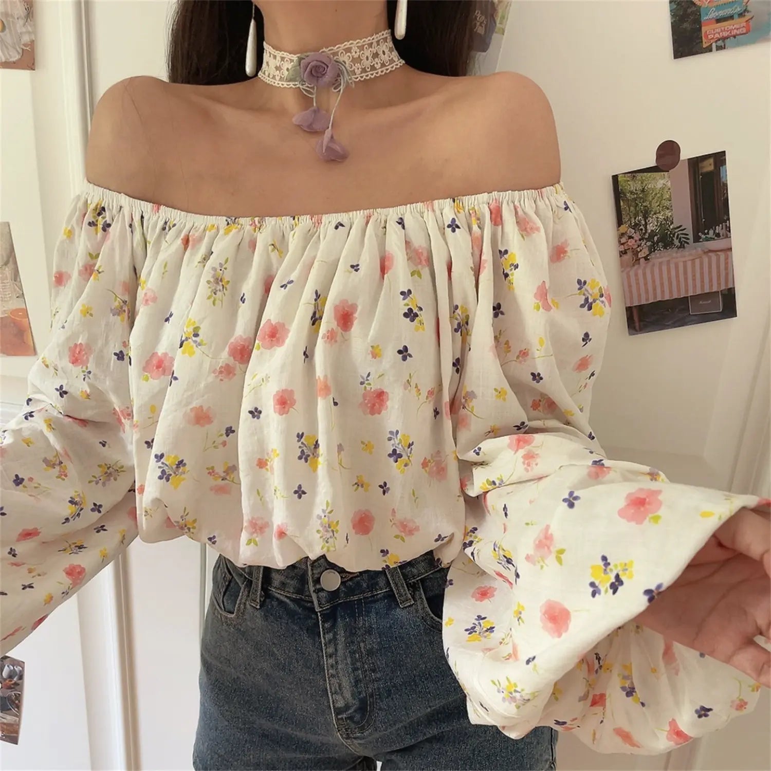 Torso close-up of ditsy floral off shoulder top, elastic gathered neckline, flowy bubble flare sleeve detail